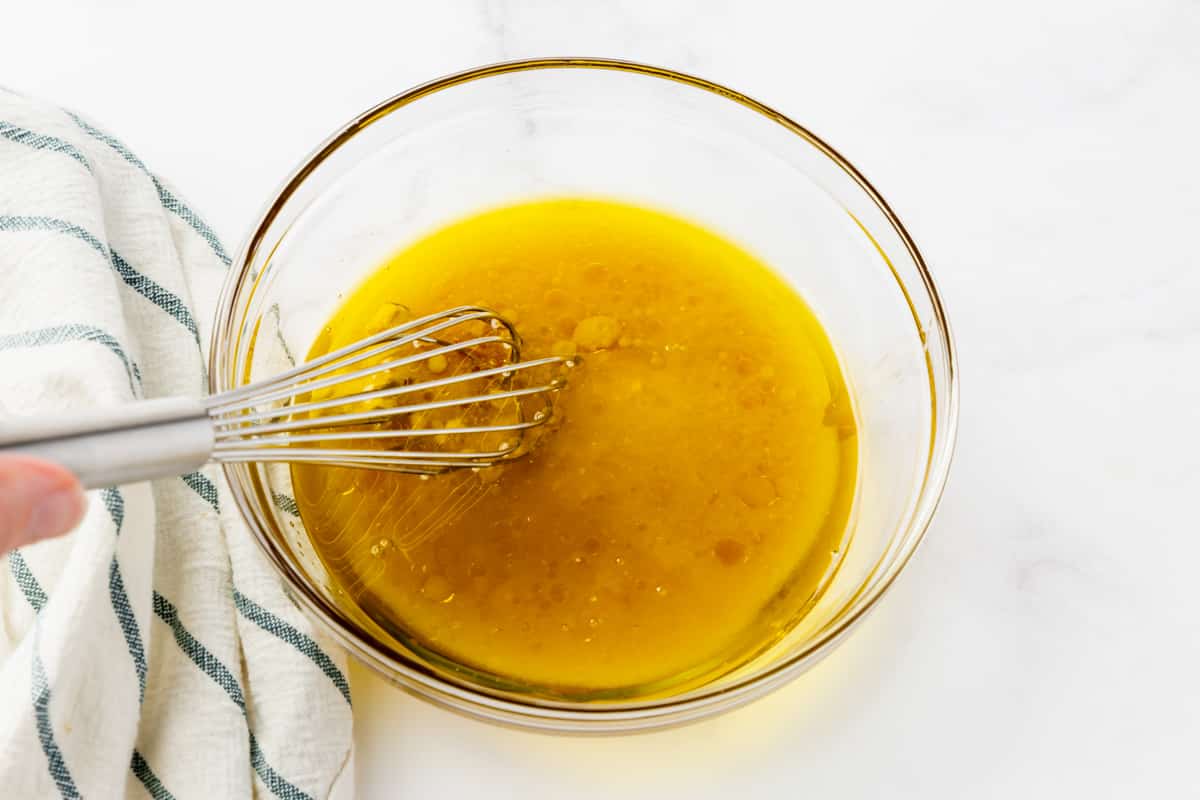 yellow liquid in clear bowl with silver whisk