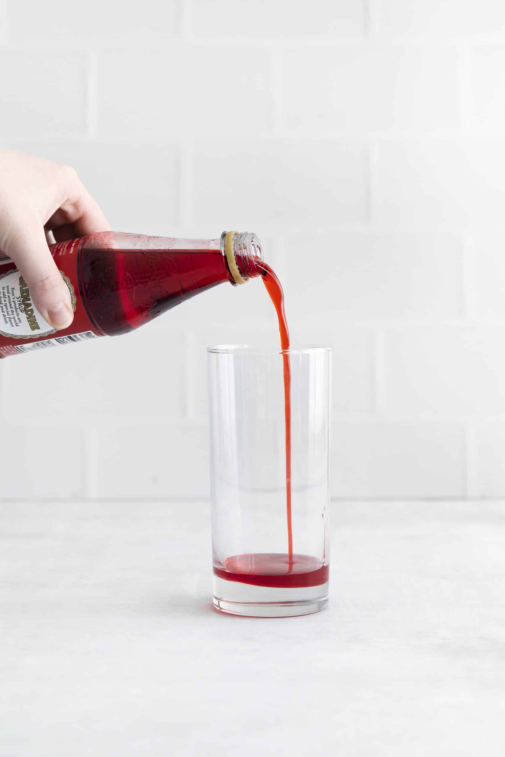 red liquid being poured into a glass