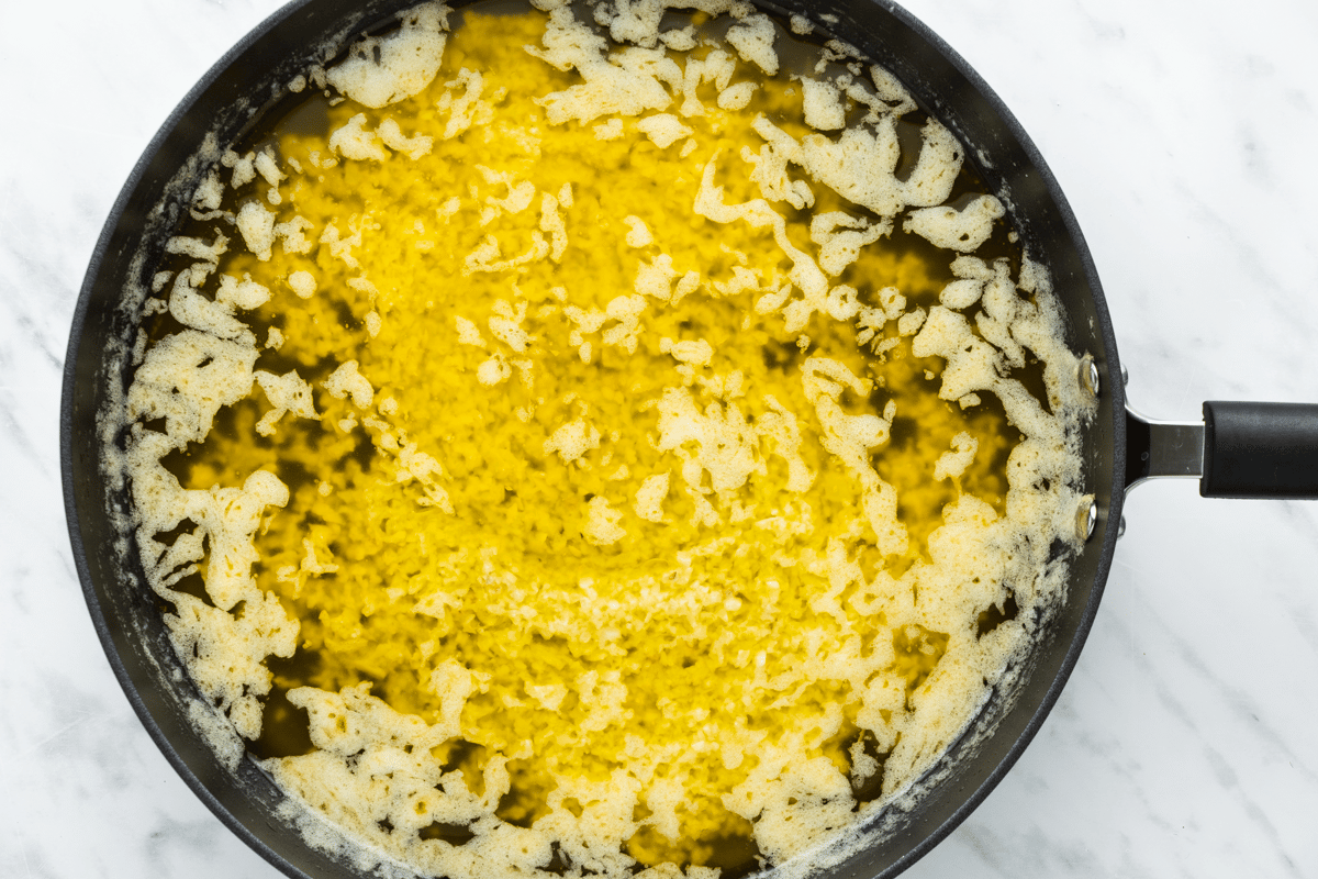 top view photo of a saucepan with onion, garlic, butter