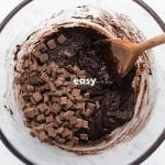 top view photo of edible brownie batter with chocolate chunks and a wooden spoon