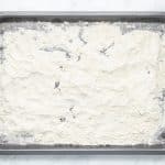 photo of all-purpose gluten free flour on a baking sheet, spread out across the pan