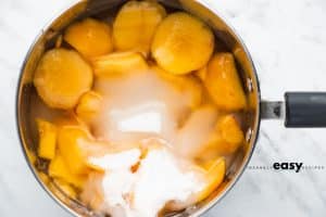 photo of ingredients to make peach simple syrup in a saucepan