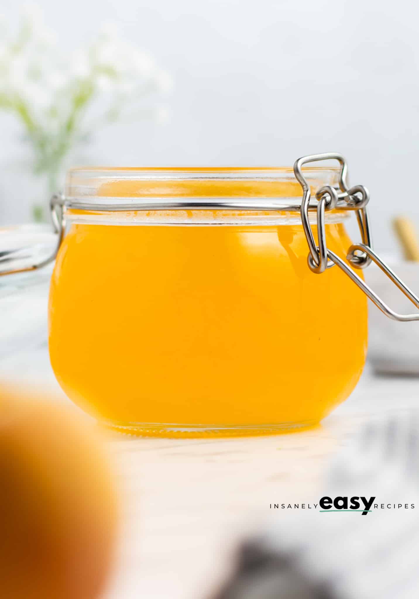 photo of peach simple syrup in a jar with the lid open
