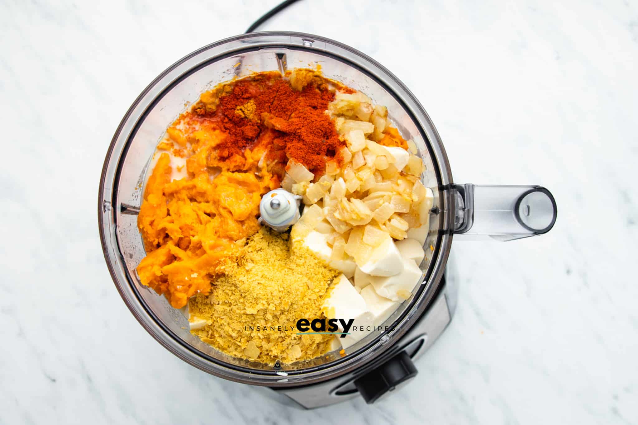 top view photo of ingredients of make sweet potato sauce in a food processor, ready to be processed