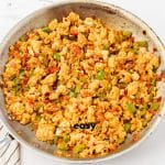 metal skillet with onions and green peppers, tofu crumbles, spices and salsa all mixed together