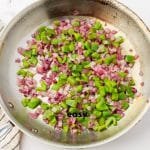 metal skillet with onions and green peppers