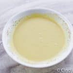 amish potato salad dressing, mixed in a white bowl.