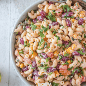 closeup photo of mexican macaroni salad in a white bowl