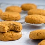 Photo of Vegan Pumpkin Cookies spread out on a baking sheet.
