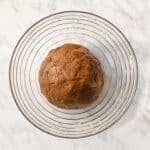 top view photo of vegan gingerbread dough in a glass bowl