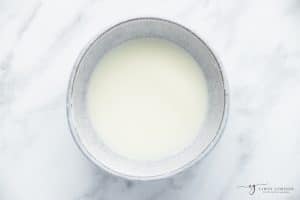 top view photo of cornstarch and water mixed in a white bowl