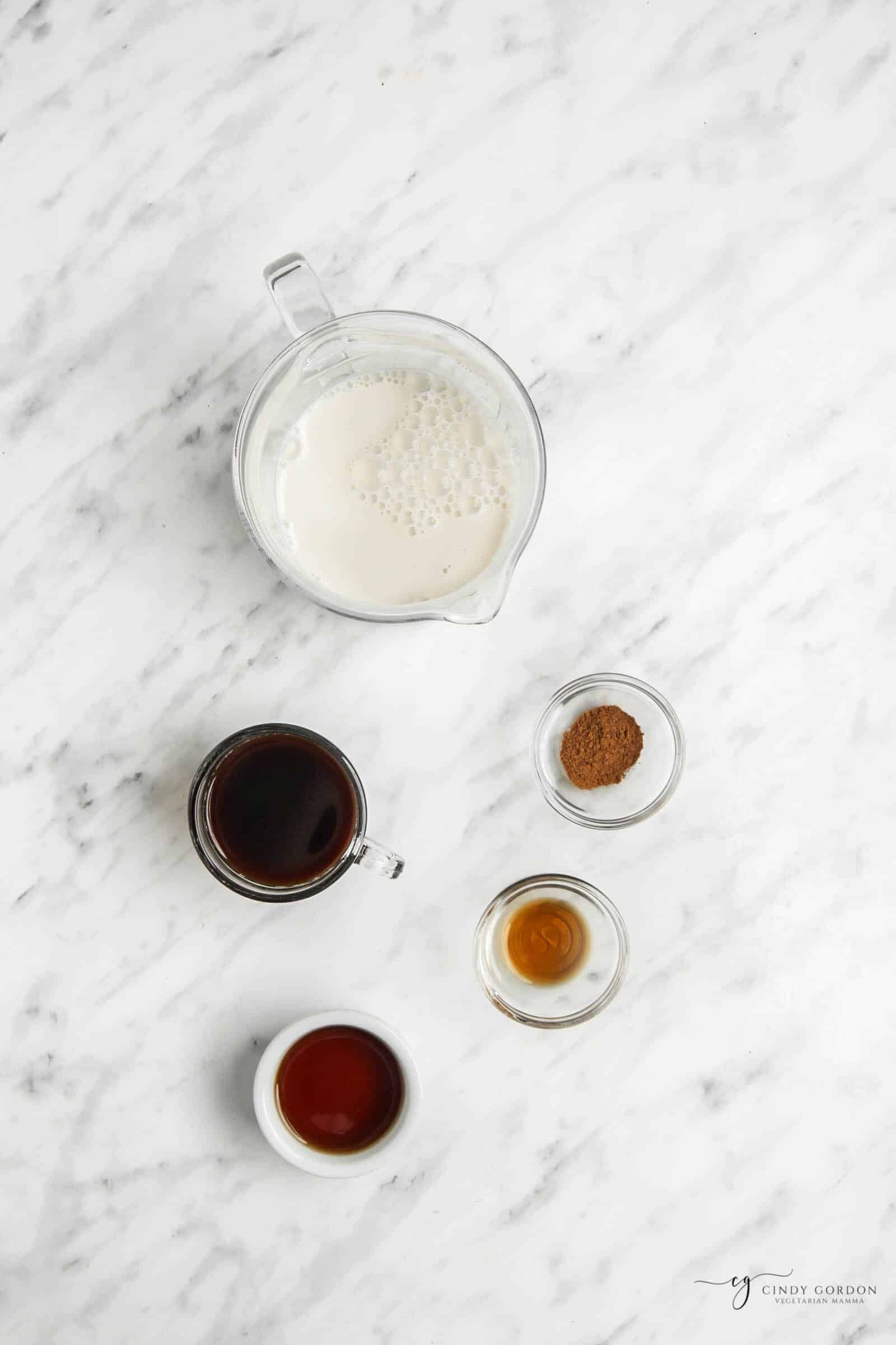Top view photo of ingredients to make Oat Milk Latte, in separate bowls.