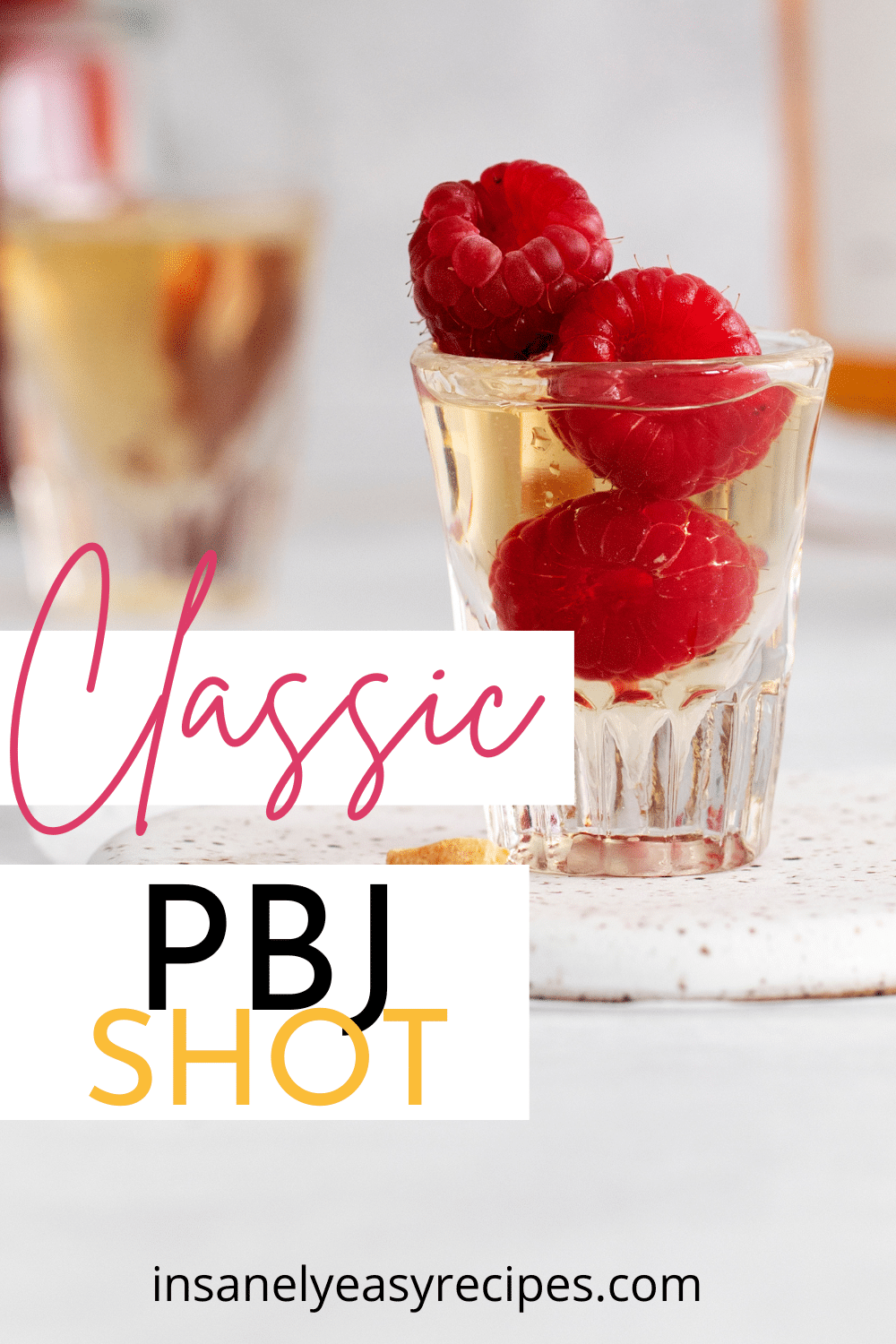 a PBJ shot with a skewer of fresh raspberries in it. Text overlay says "classic PBJ Shot"
