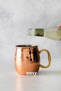 Photo of ginger bear being poured into a copper mug to make a London Mule cocktail.
