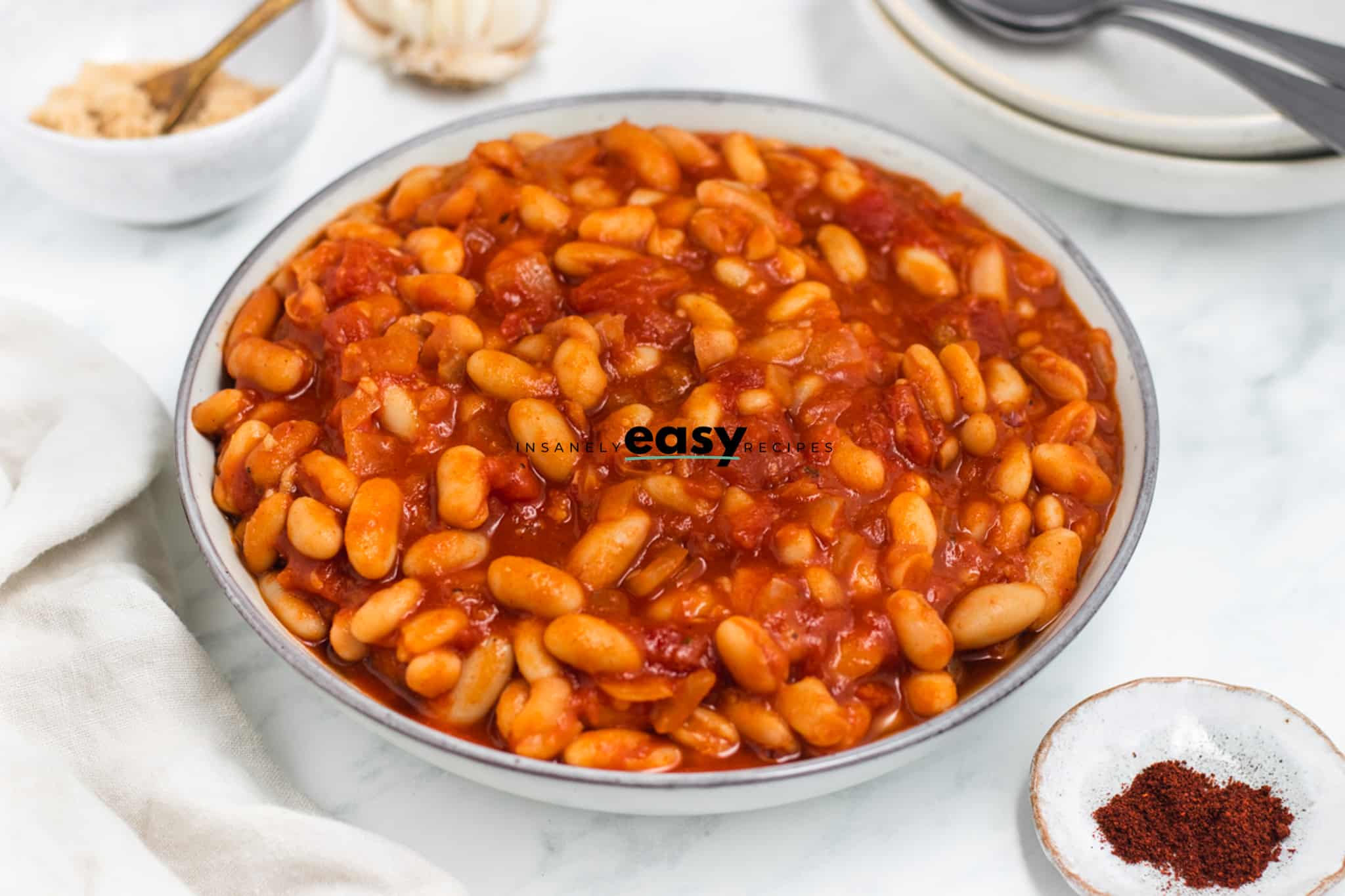 a large bowl of vegan baked beans on a table. 