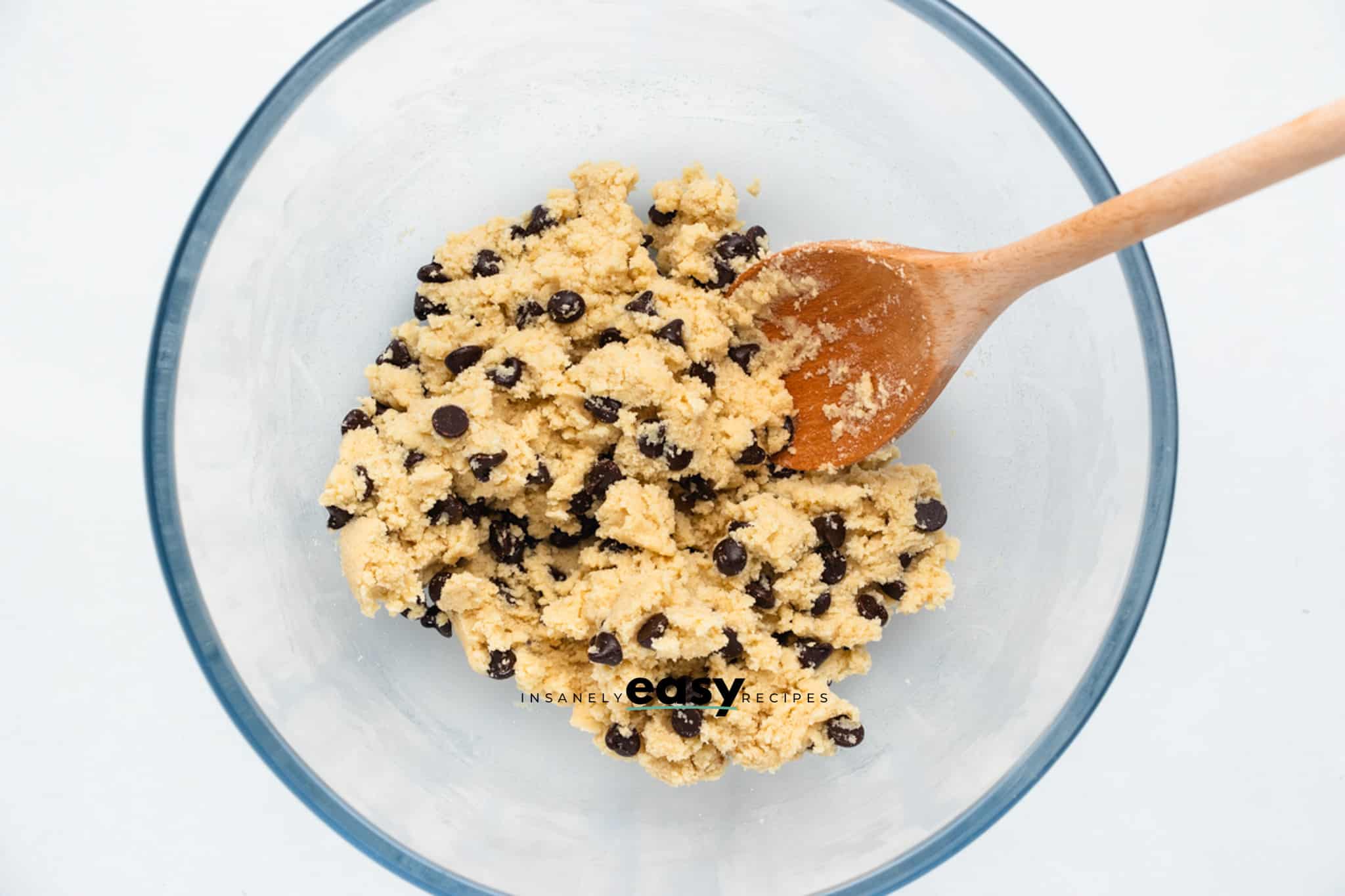 Top view photo of a glass bowl with the dough to make No Bake Cookie Dough Bites mixed together with chocolate chips.
