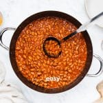 a large pot of beans. A ladle is holding up a serving of ranch beans.