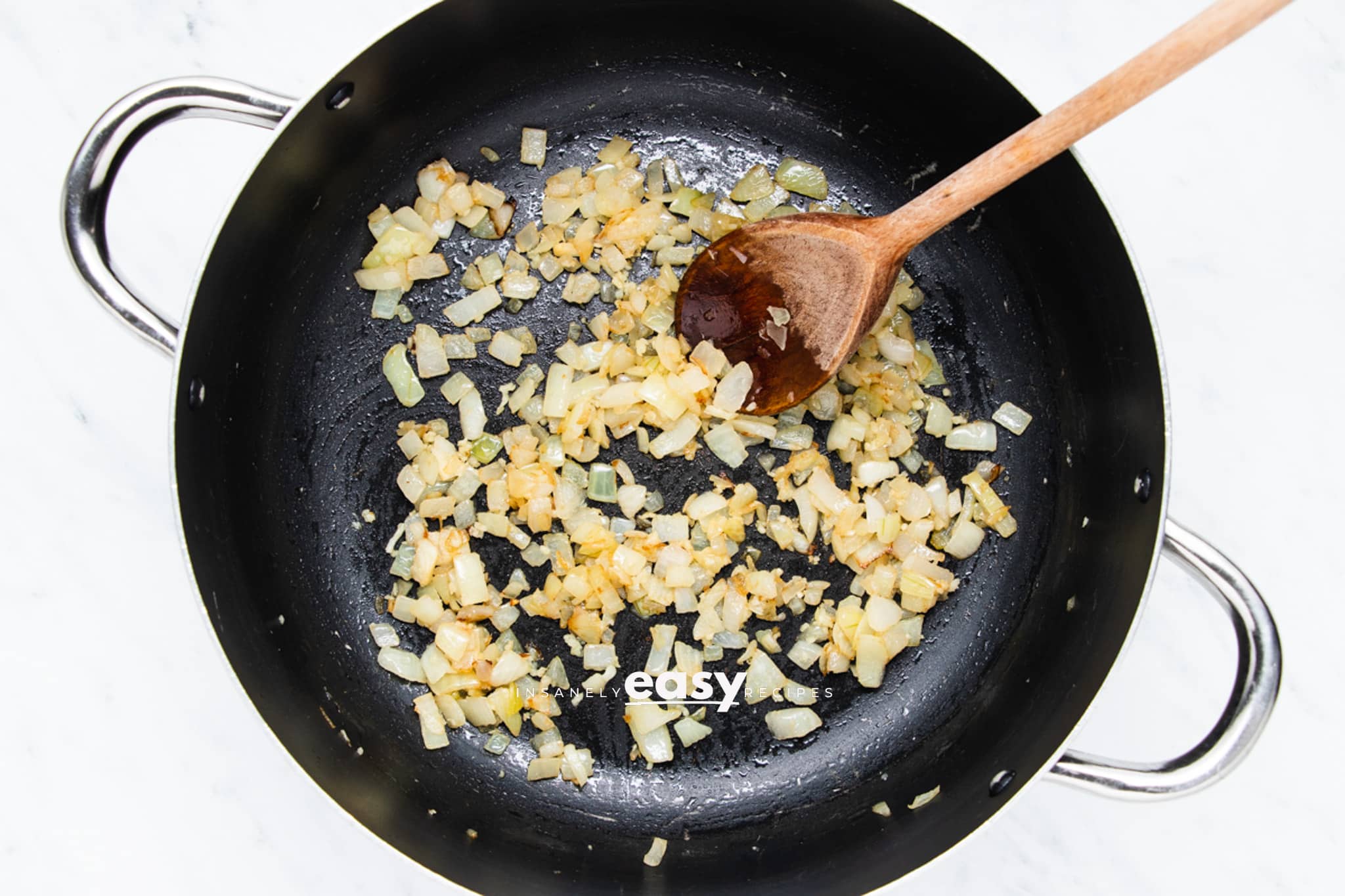 onion and garlic sauteing in a saucepan.