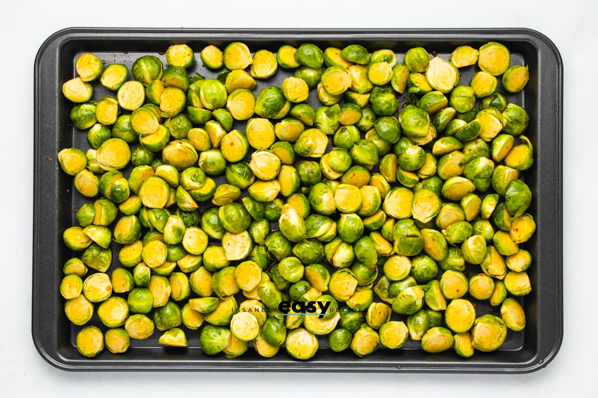 halved brussels on a sheet pan.