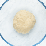 a ball of fresh tortilla dough in a glass bowl