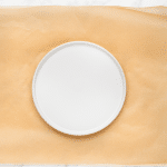 a round white plate on top of parchment paper.