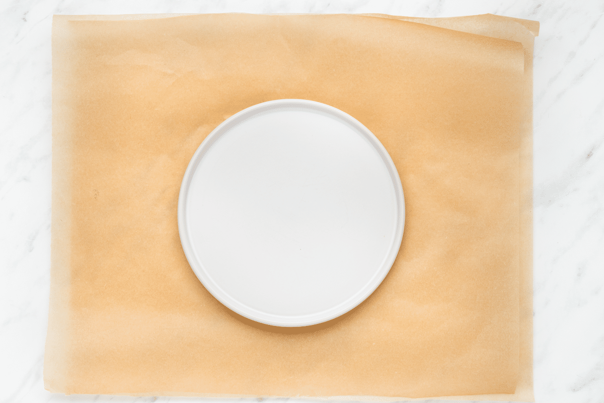 a round white plate on top of parchment paper.
