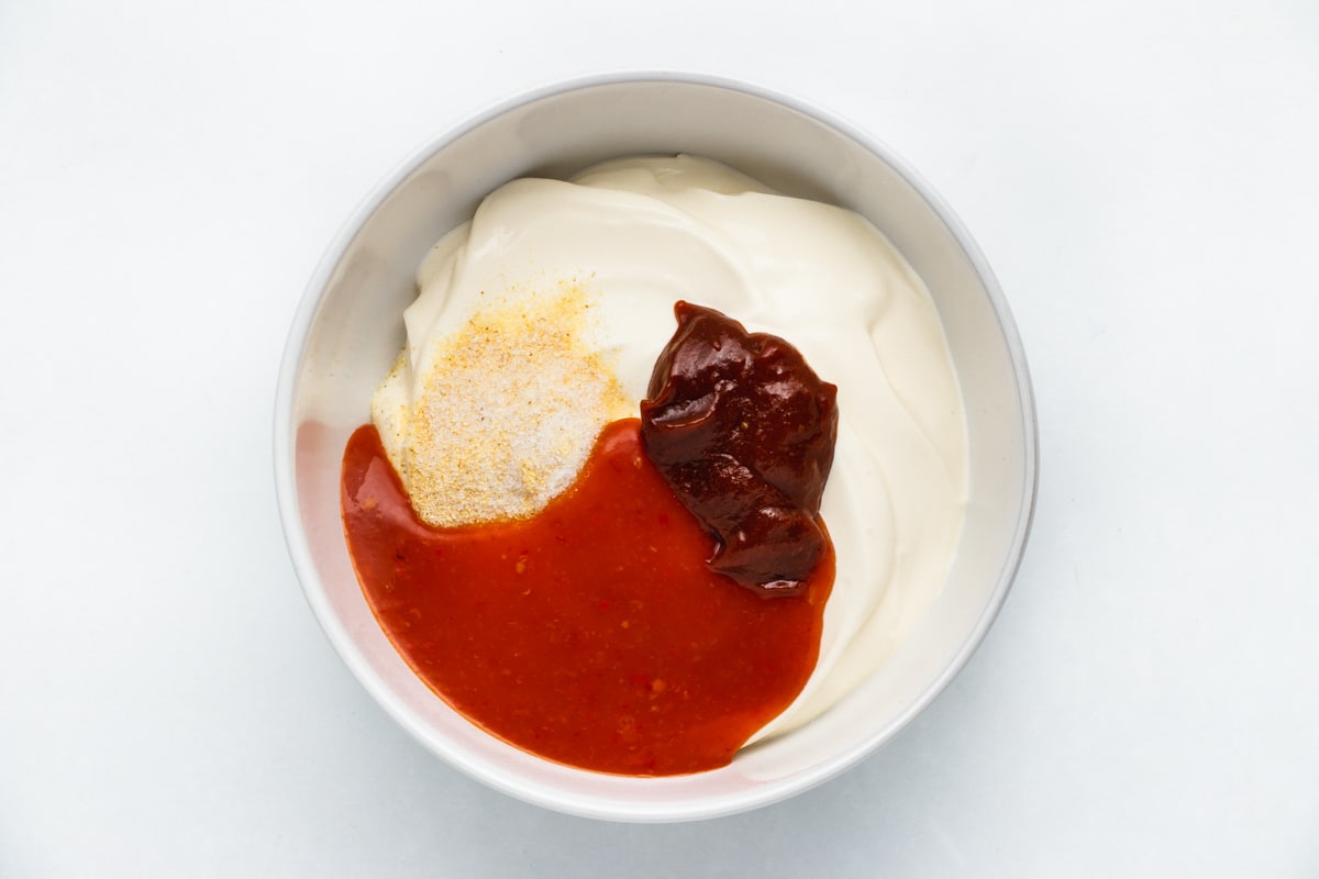 Sour Cream, chipotle paste, hot sauce and seasonings , in a bowl.