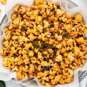 a large bowl of popcorn seasoned with chili powder and jalapenos