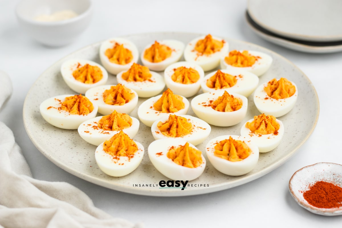 a round plate filled with million dollar deviled eggs