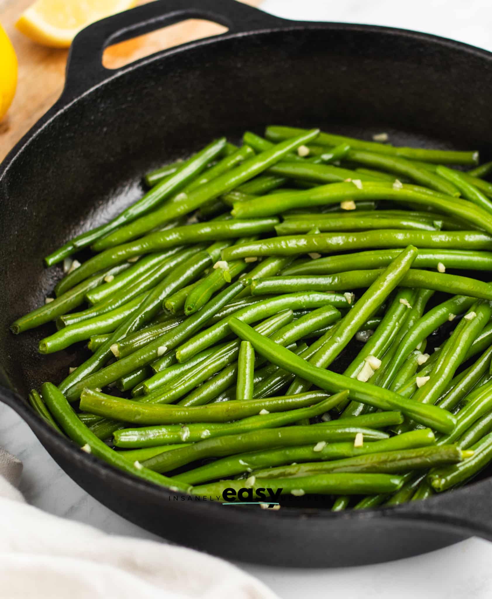 a skillet of green beans sauteed with garlic