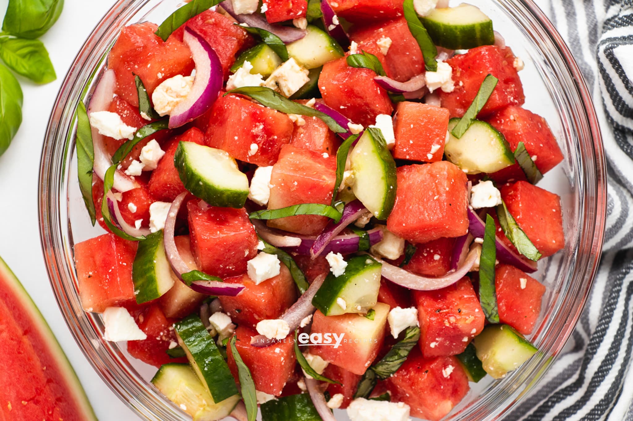 Closeup photo of Watermelon Basil Salad in a glass bowl.